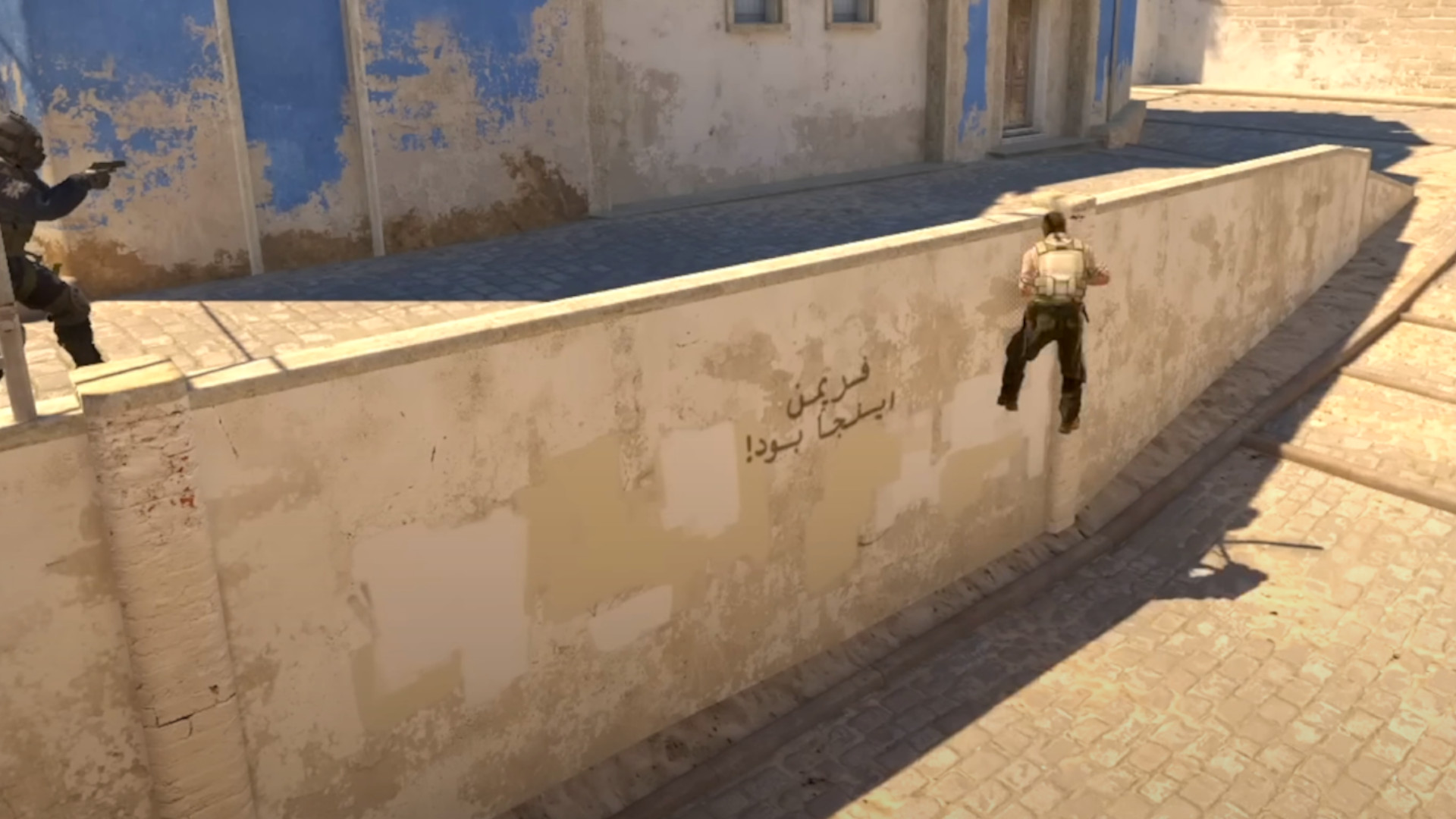 Screenshot of the CS2 glitch where someone can slide up the wall in Mid on Mirage