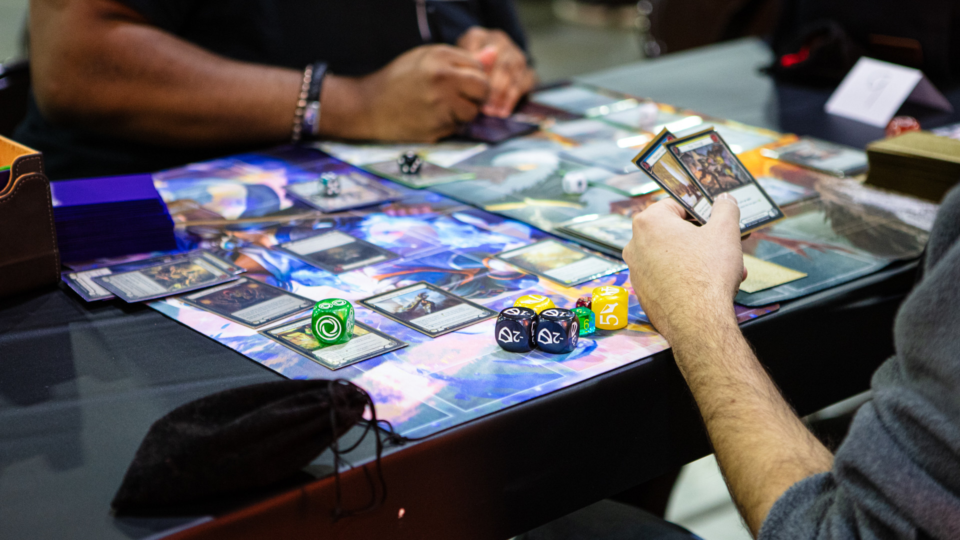 Two players playing a tabletop card game