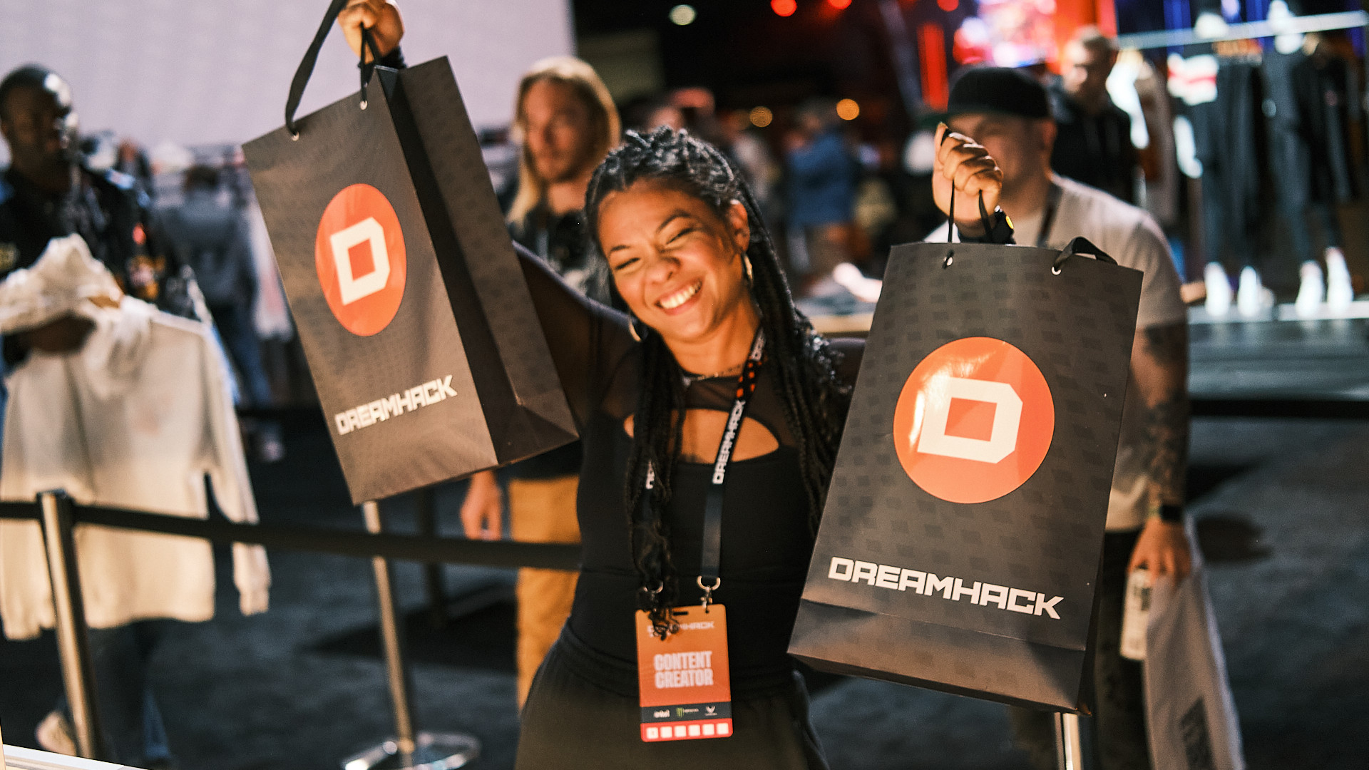 Woman holding two bags with the DreamHack logo on it